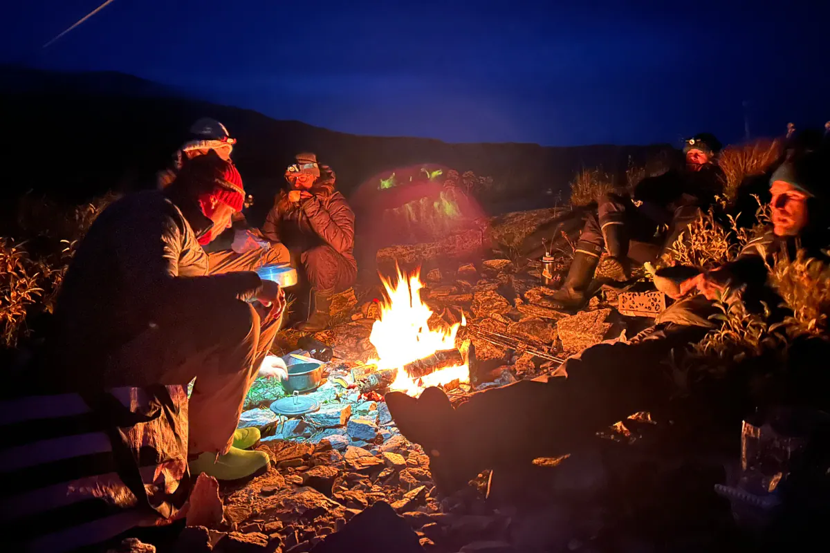Anglers around a campfire at night