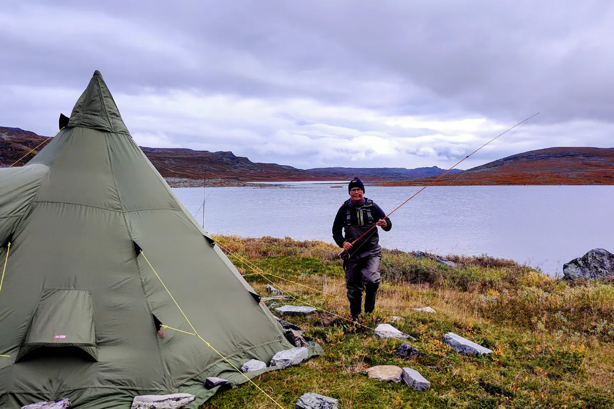 Tipi tent by a remote lake