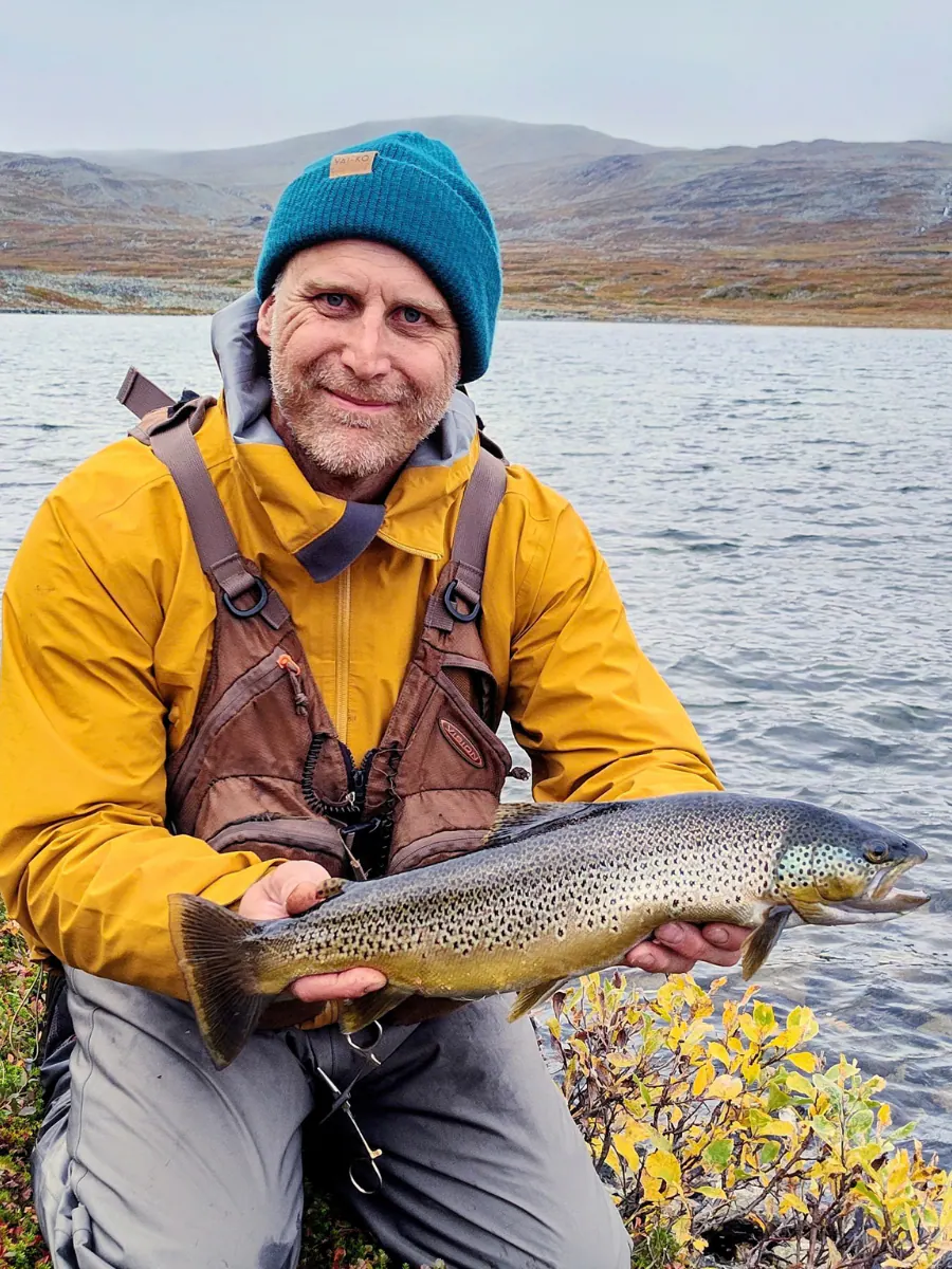Angler holding a golden wild brown trout