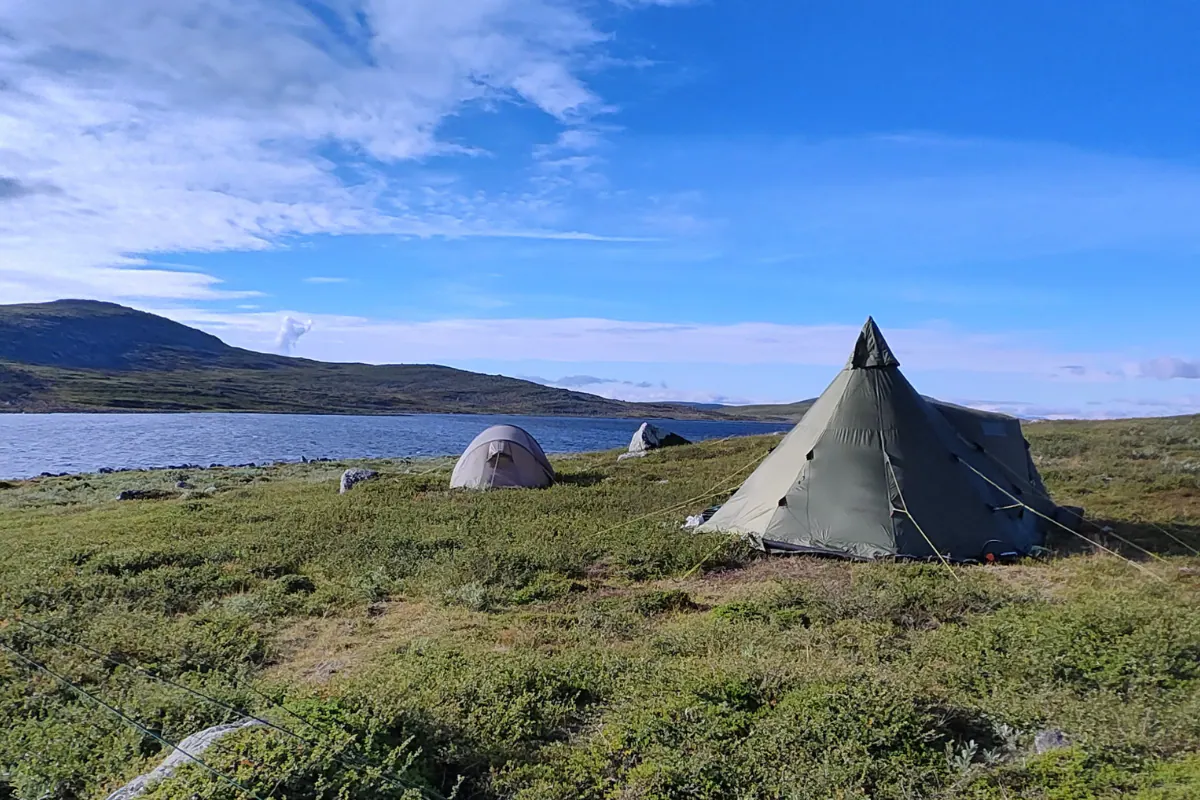 Tipi tent camp on a lake shore