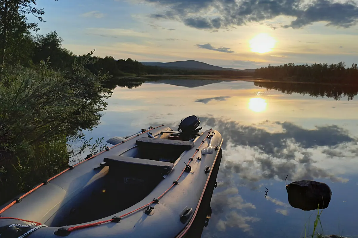 Rubber boat on a calm river in the midnight sun