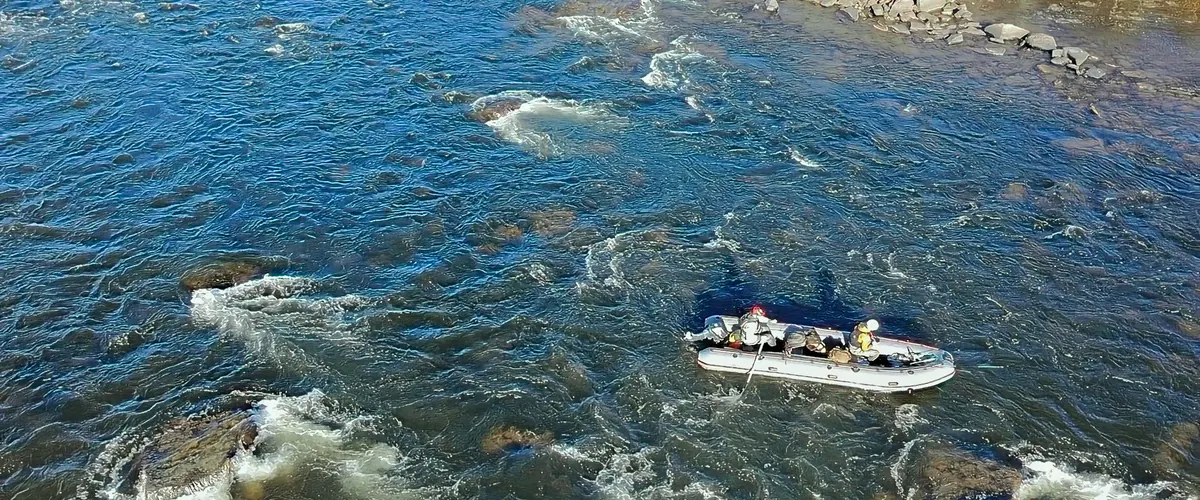 Aerial view of a raft on a fast Lapland river
