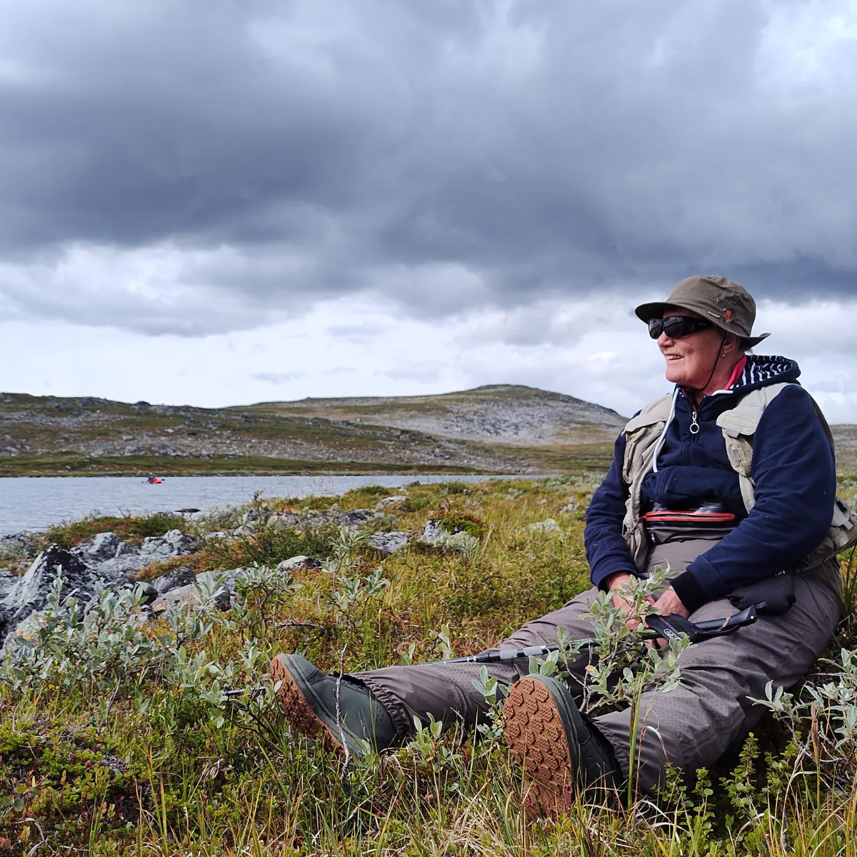 Guide resting on a fell with fishing gear