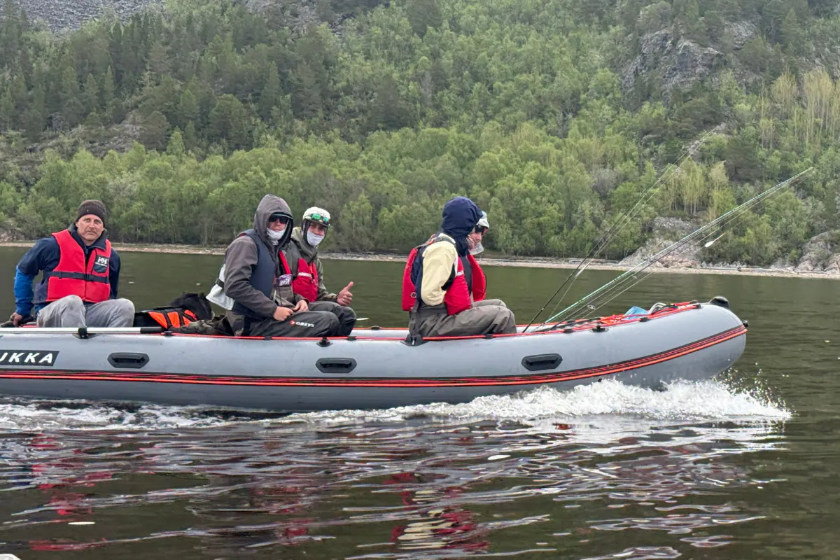 Rubber boat with anglers crossing a fjord