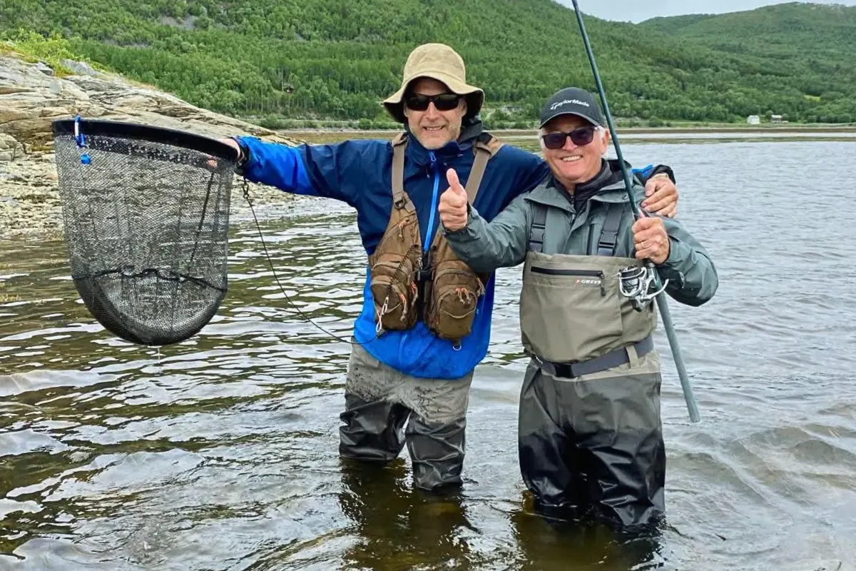 Two anglers with a landing net in the fjord