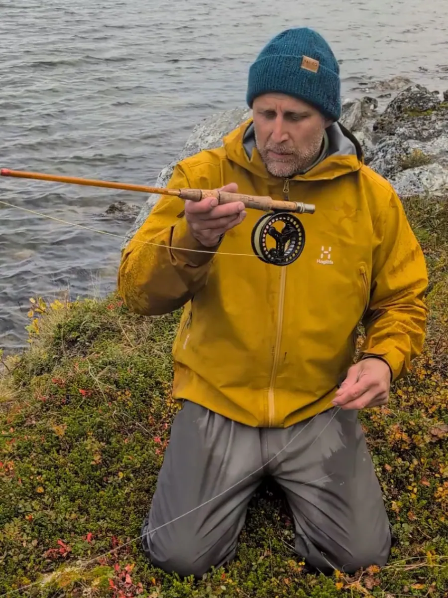 Teemu holding a fly rod and reel