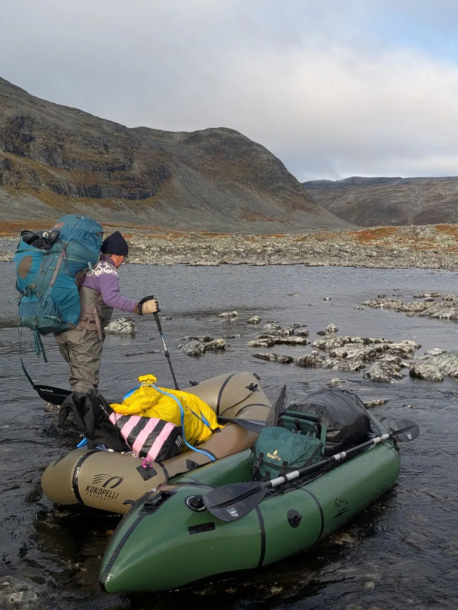 Backpack and fishing gear ready by the river