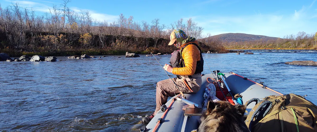 Angler in waterproof layers in a rubber boat